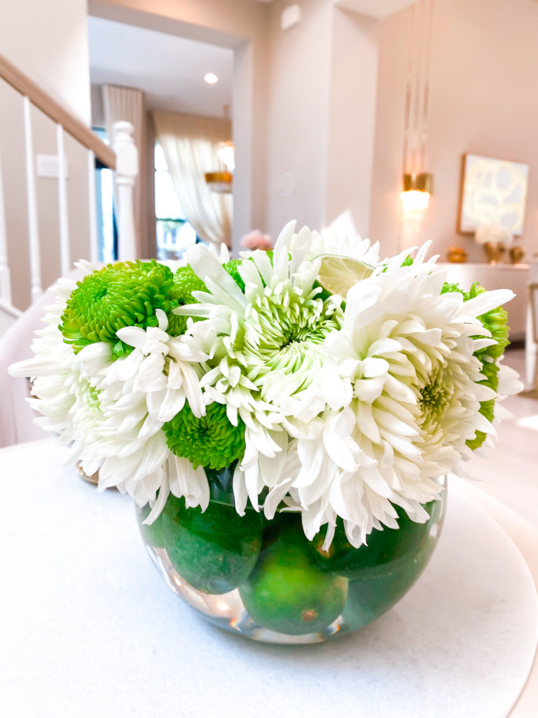 A WHITE AND GREEN FLORAL ARRANGEMENT WITH LIME AND CARNATIONS