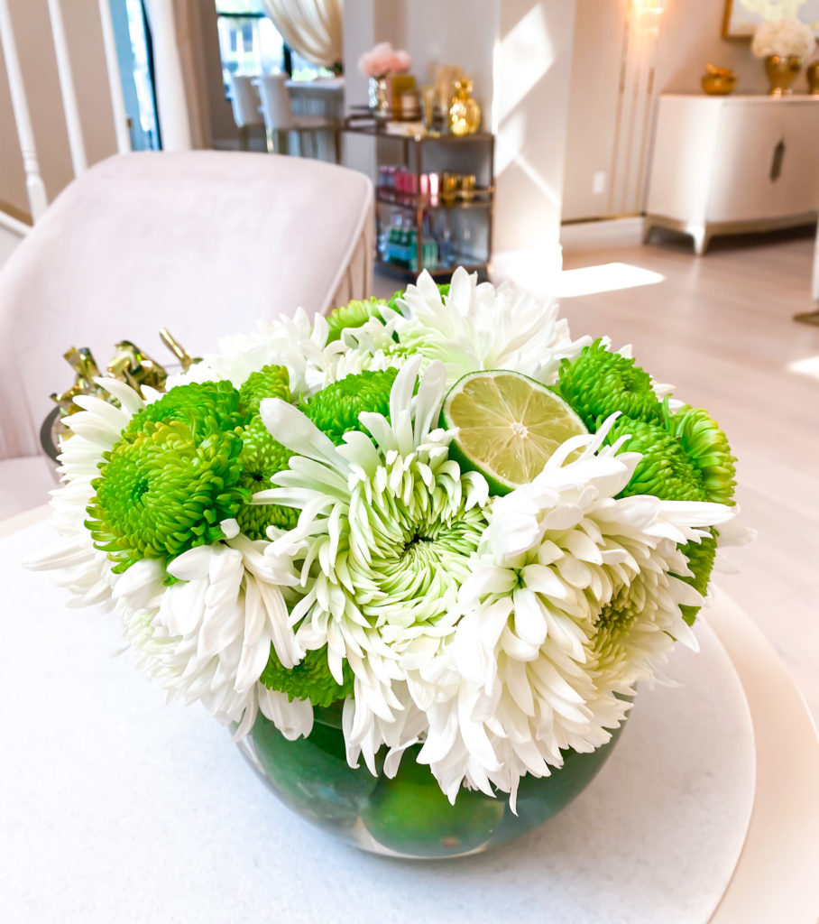 A WHITE AND GREEN FLORAL ARRANGEMENT WITH LIME AND CARNATIONS