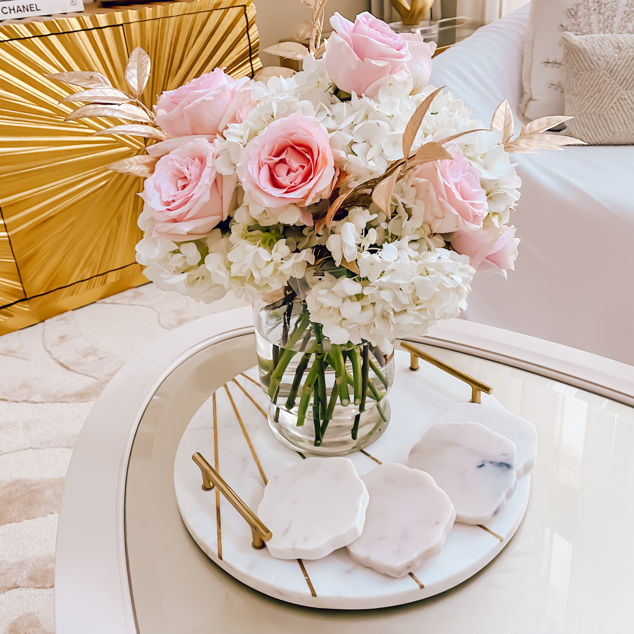 A ROSE FLOWER ARRANGEMENT WITH A TOUCH OF GOLD
