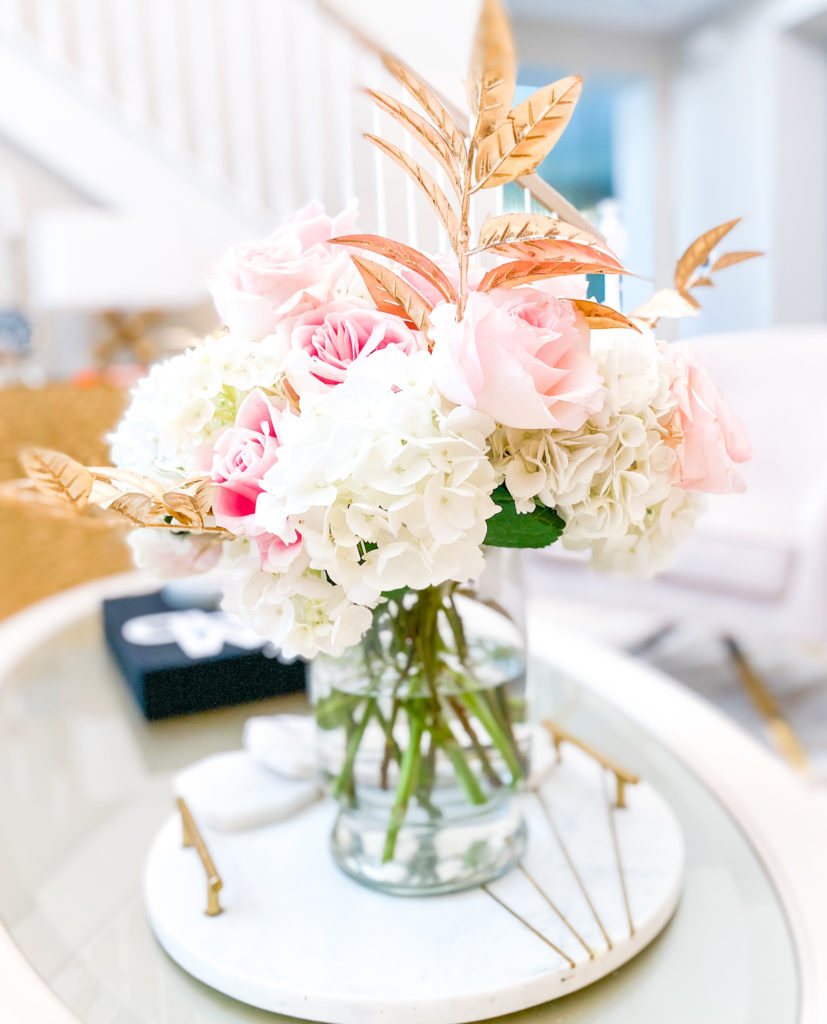 A ROSE FLOWER ARRANGEMENT WITH A TOUCH OF GOLD