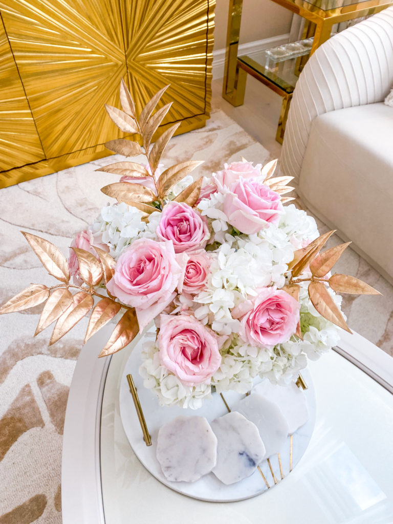 A ROSE FLOWER ARRANGEMENT WITH A TOUCH OF GOLD