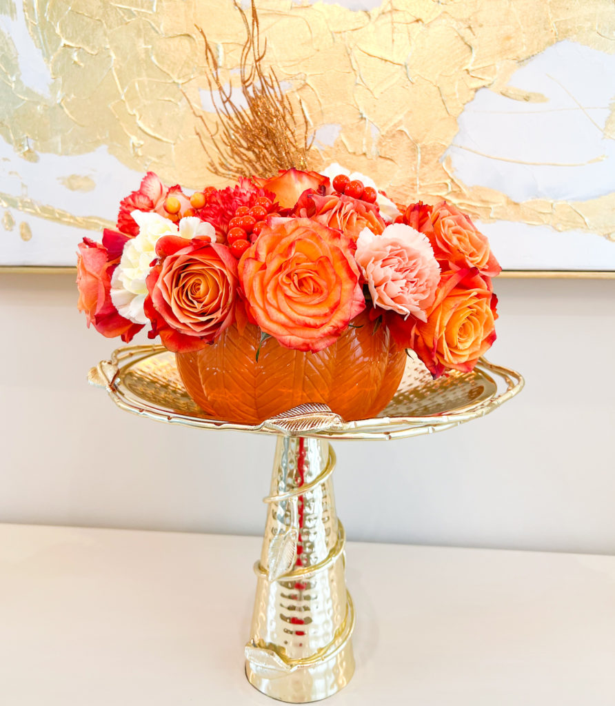fall flowers in a pumpkin vase