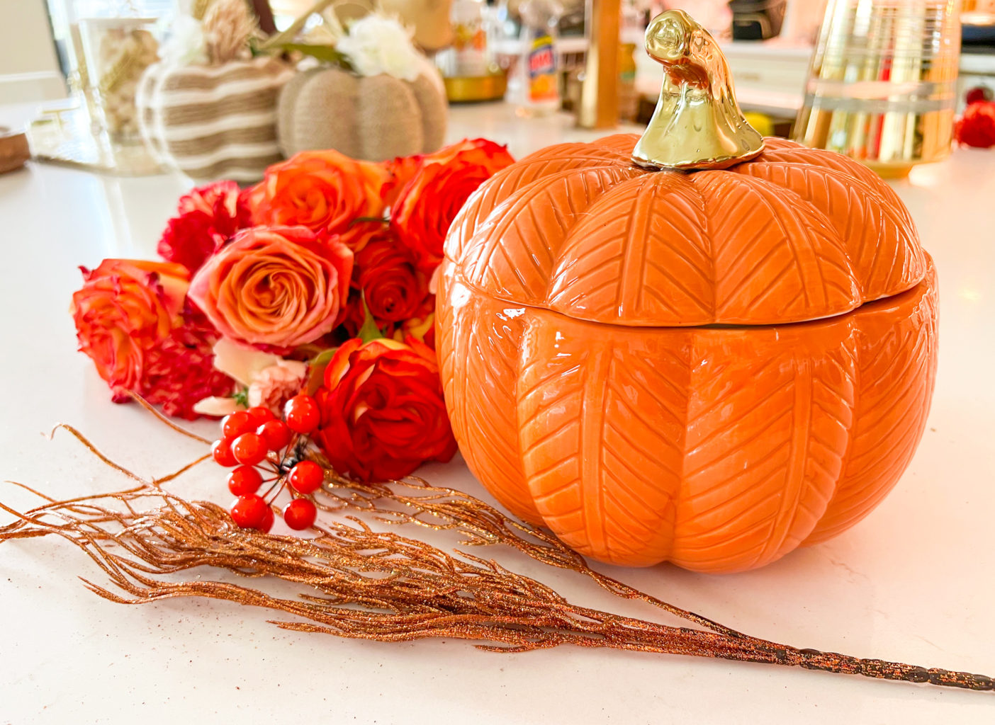 fall flowers in a pumpkin vase