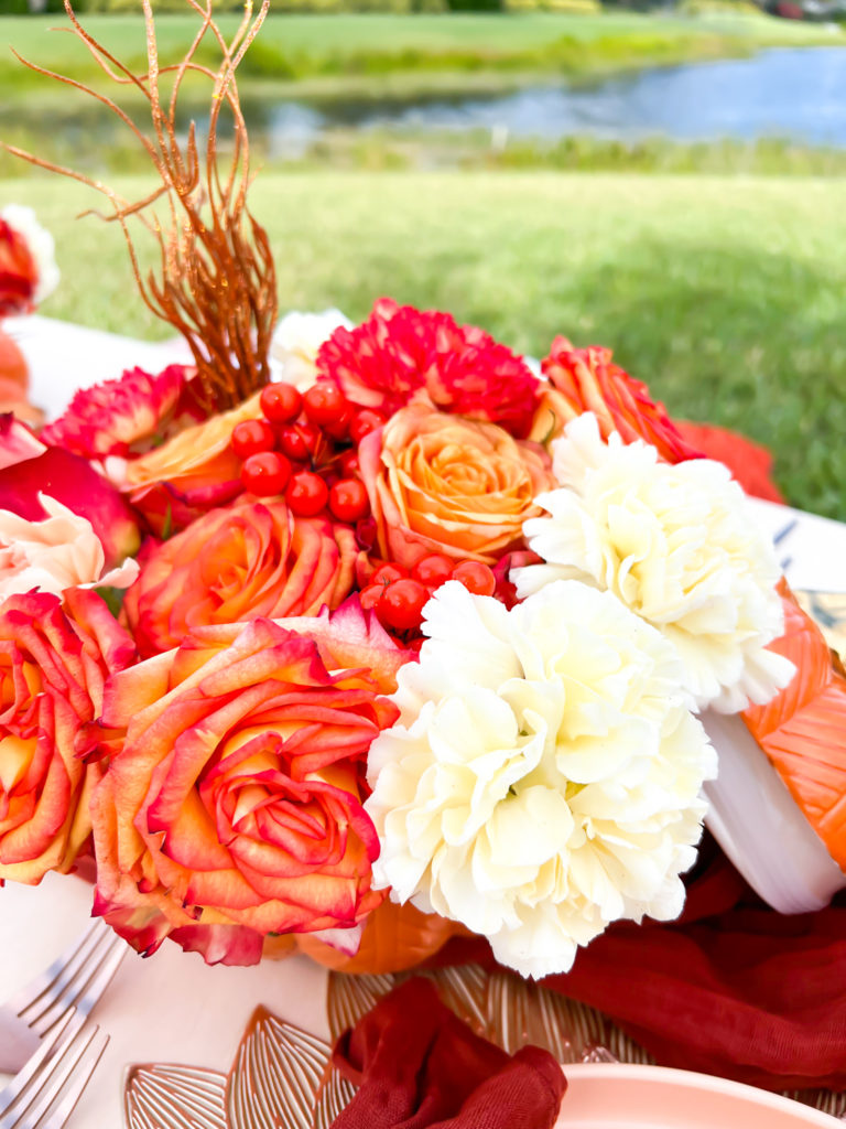 fall flowers in a pumpkin vase
